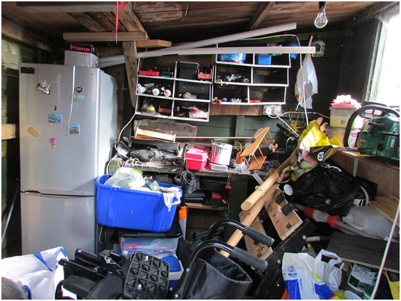 Picture showing cluttered garage befor a Junk Boy cleanout